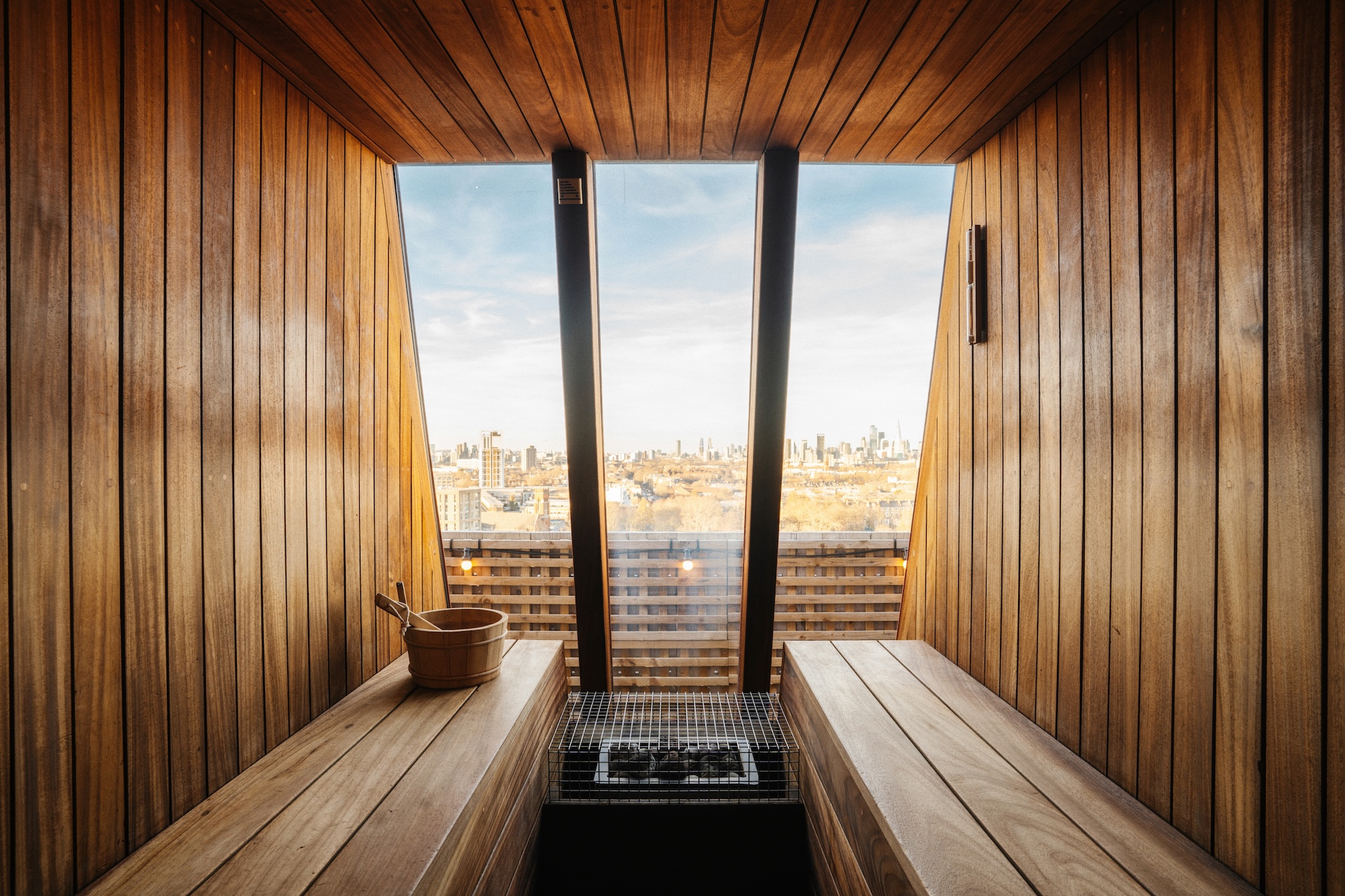 Private sauna cabin and cold plunge at Rooftop Saunas Brixton, with views of London