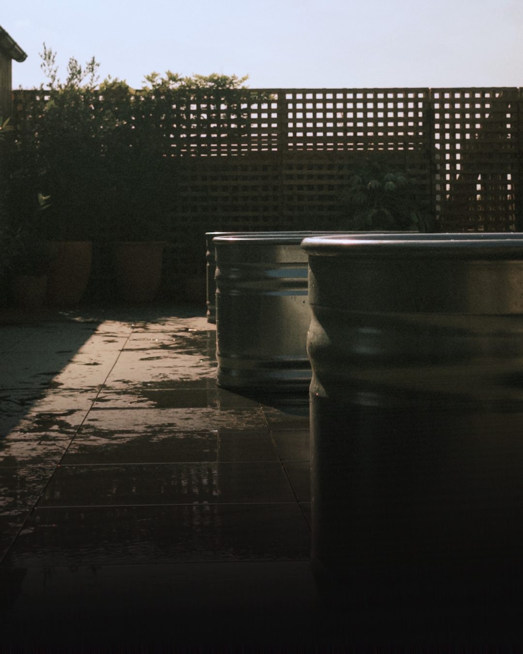 Cold plunge tubs on the roof terrace in evening light